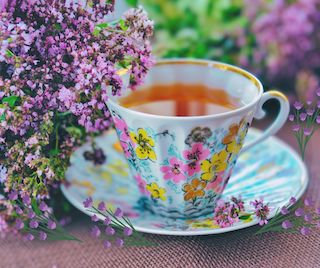 purple flowers and floral teacup with saucer